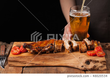 Pork ribs and light beer. Pork ribs and light beer. 48020534