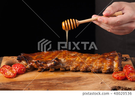 Cooking pork rib chops with honey sweet sauce. 48020536