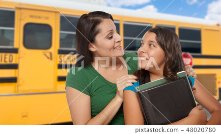 Hispanic Mother and Daughter Near School Bus. Hispanic Mother and Daughter Near School Bus. 48020780