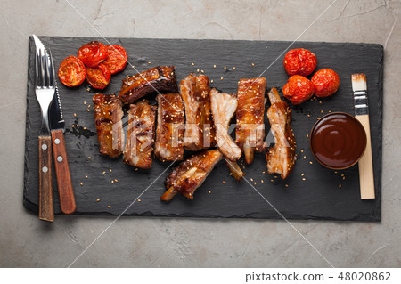 Grilled pork ribs in barbecue sauce. 48020862