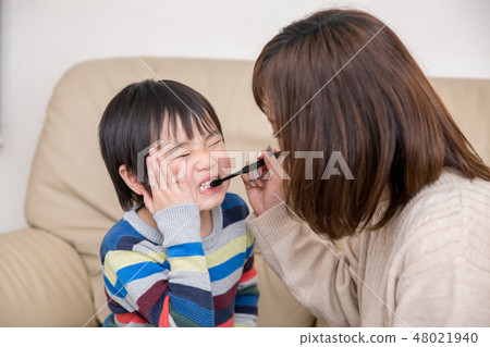 A boy who dislikes tooth brushing A boy who dislikes tooth brushing 48021940