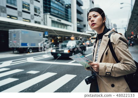 traveler walking on zebra crossing finding hotel 48022133