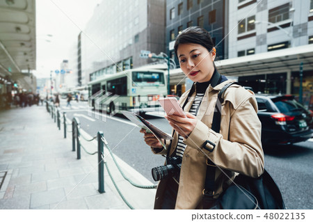 asian female tourist using online city guide 48022135