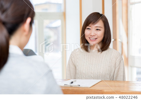 A woman listening at the reception 48022246