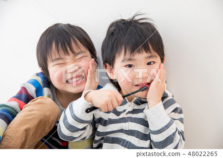 Brothers holding teeth 48022265