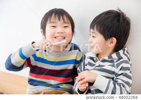 Brothers brushing teeth Brothers brushing teeth 48022268