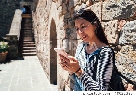 woman using cellphone checking the information woman using cellphone checking the information 48022383