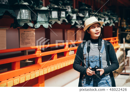 tourist holding camera cheerful visit 48022426