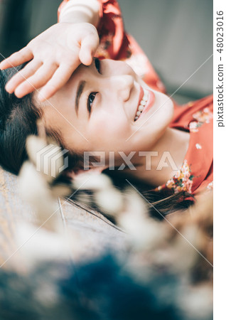 A red one-piece lady lying on the floor 48023016