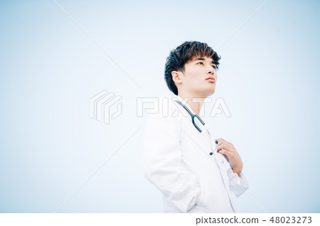 Male in white coat standing on the roof 48023273