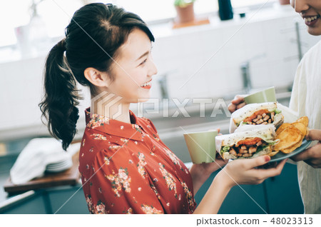 Men and women hand over sandwiches in the kitchen 48023313