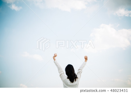 A woman in a white shirt standing on the roof A woman in a white shirt standing on the roof 48023431