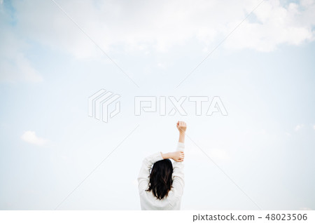 A woman's back on a roof-top white shirt 48023506