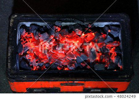 Charcoal in red tractor, flame in orange 48024249