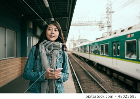 Young asian woman checking timetable online Young asian woman checking timetable online 48025685