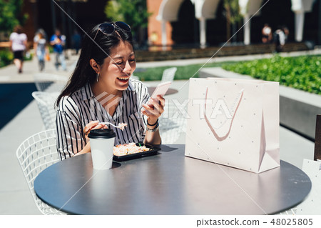 girl having lunch with coffee center mall. 48025805