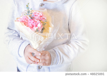 A boy with a bunch of carnations A boy with a bunch of carnations 48025891