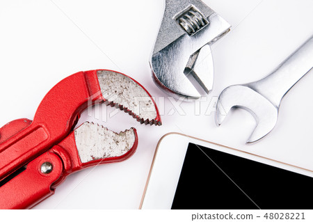 Plumbing key with a smartphone on a white background 48028221