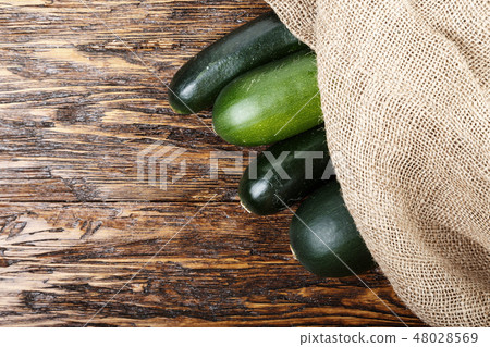 Raw zucchini on a wooden background 48028569