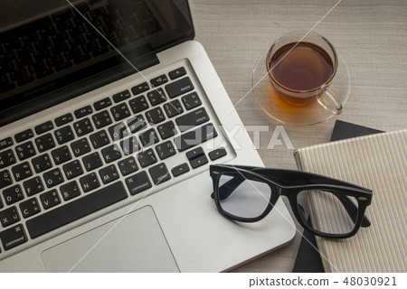 Laptop and one glass of work area Laptop and one glass of work area 48030921