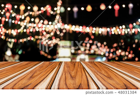 Selective Empty wooden table in front of abstract blurred festiv 48031384