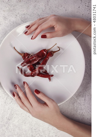 Beautiful female hand with red manicure Beautiful female hand with red manicure 48031741