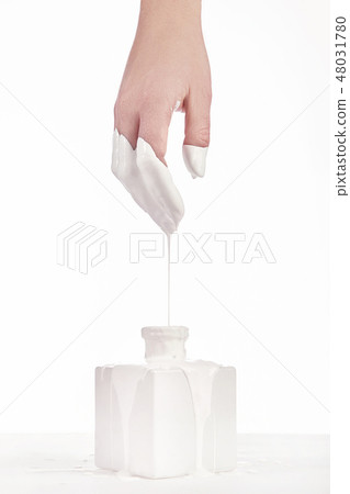Beautiful woman hand with her white paint dripping 48031780