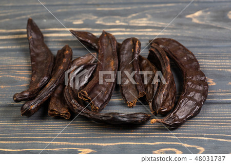 Carob. Healthy organic sweet carob pods  48031787
