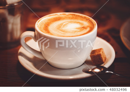 coffee cup with latte art and brown sugar 48032496