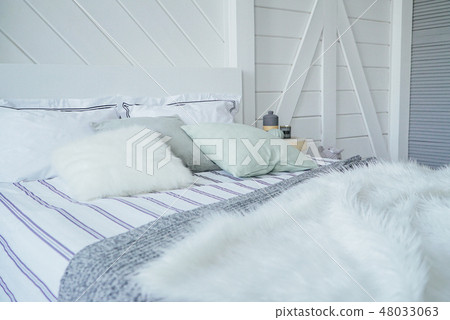 Bed with pillows and fur knitted blanket  48033063