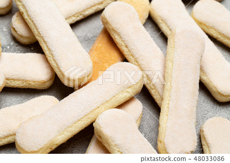 Italian Savoiardi ladyfingers Biscuits on concrete backgound 48033086