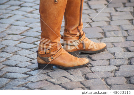 feet of woman with brown classic boots feet of woman with brown classic boots 48033115