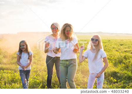 Friendship, Indian holidays and people concept - young women and children dancing on the summer 48033240