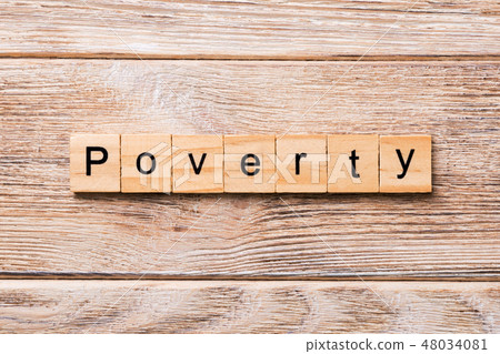 Poverty word written on wood block. Poverty word written on wood block. 48034081