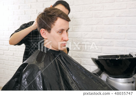 Female barber haircut doing male hair style Female barber haircut doing male hair style 48035747