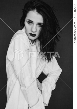 fashion portrait of attractive brunette girl posing in white shirt fashion portrait of attractive brunette girl posing in white shirt 48036533