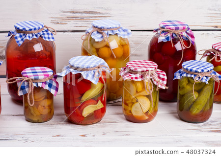 Glass jars with canned food. 48037324