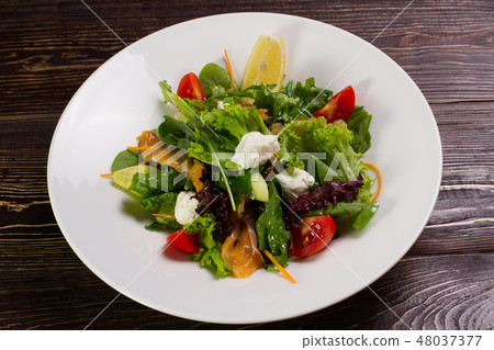 Salad with salmon and vegetables. Salad with salmon and vegetables. 48037377