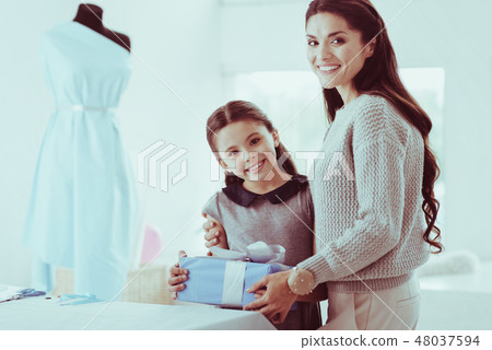 Positive family holding a present Positive family holding a present 48037594