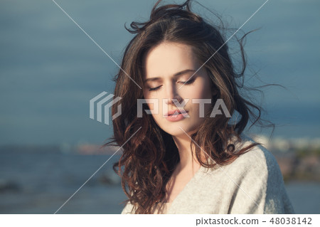 Young woman outdoors on spring sea 48038142