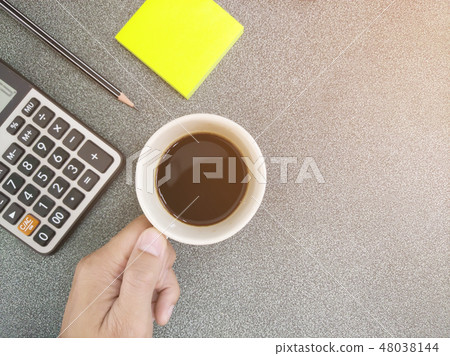 Coffee cup holders are on the desk. 48038144