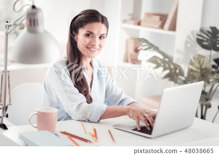 Motivated young mother creating business plan for new start up Motivated young mother creating business plan for new start up 48038665