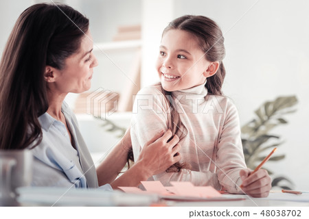Little hazel-eyed girl having a spark of inspiration with her mother 48038702