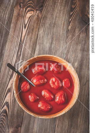 Bowl of canned tomatoes Bowl of canned tomatoes 48041459