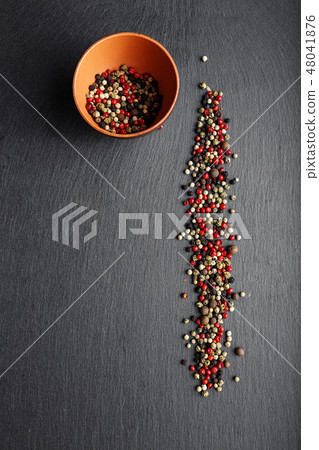 pepper on a slate board pepper on a slate board 48041876