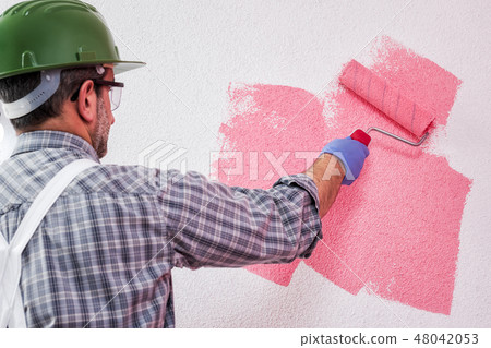House painter at work painting the wall 48042053
