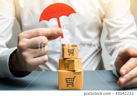 A man holding an umbrella above the boxes 48042231