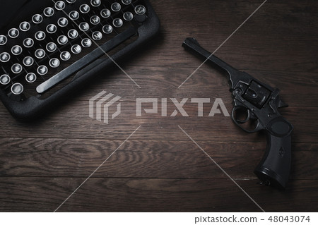 Crime fiction old retro vintage typewriter and gun Crime fiction old retro vintage typewriter and gun 48043074