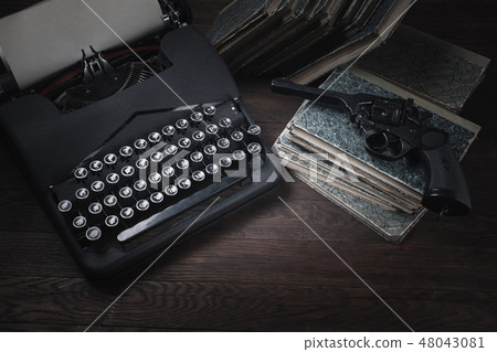 Crime fiction old retro vintage typewriter and gun Crime fiction old retro vintage typewriter and gun 48043081