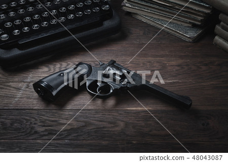 Crime fiction old retro vintage typewriter and gun Crime fiction old retro vintage typewriter and gun 48043087